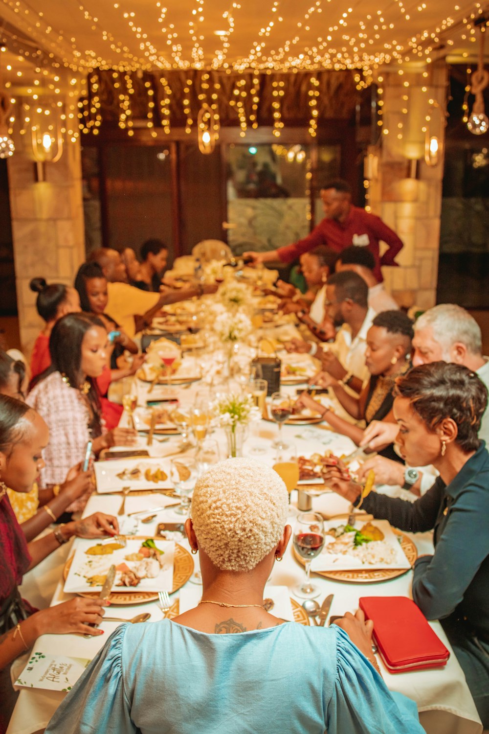 a group of people sitting at a long table