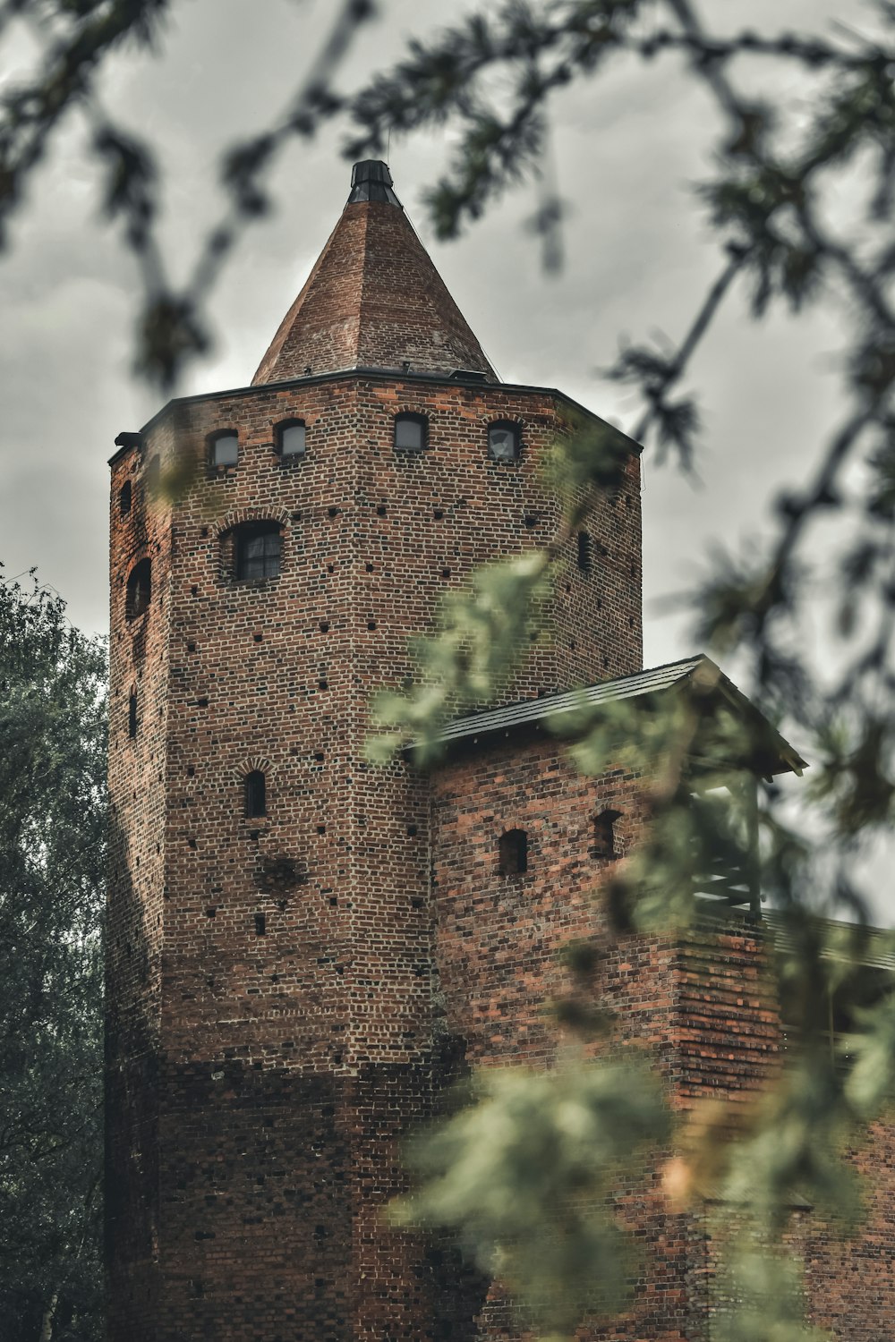 a tall brick tower with a clock on it's side