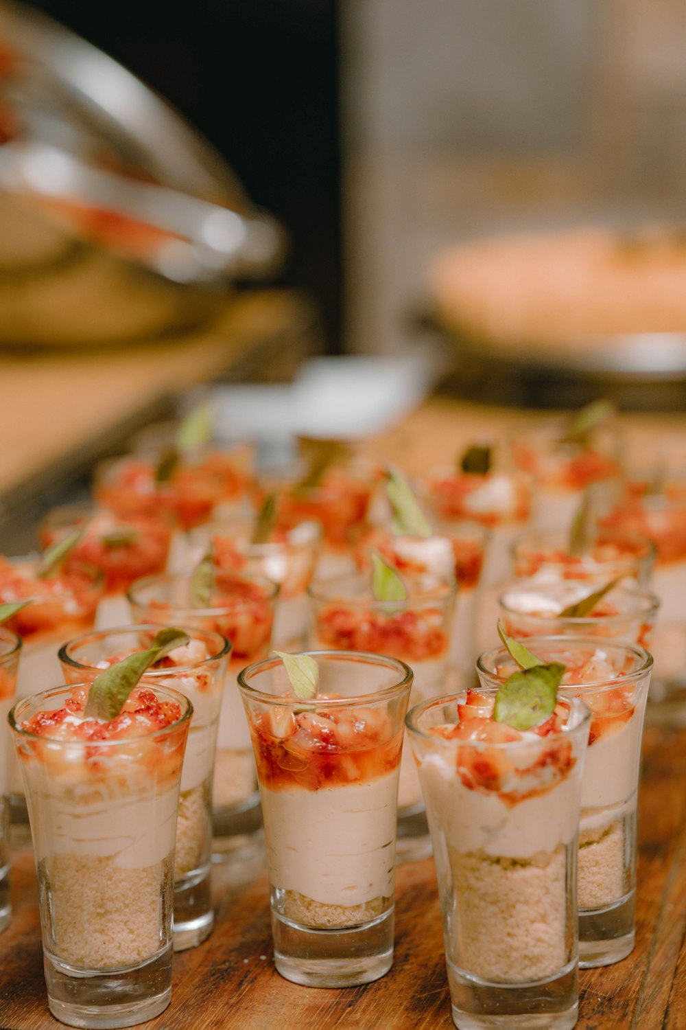 a wooden table topped with glasses filled with food