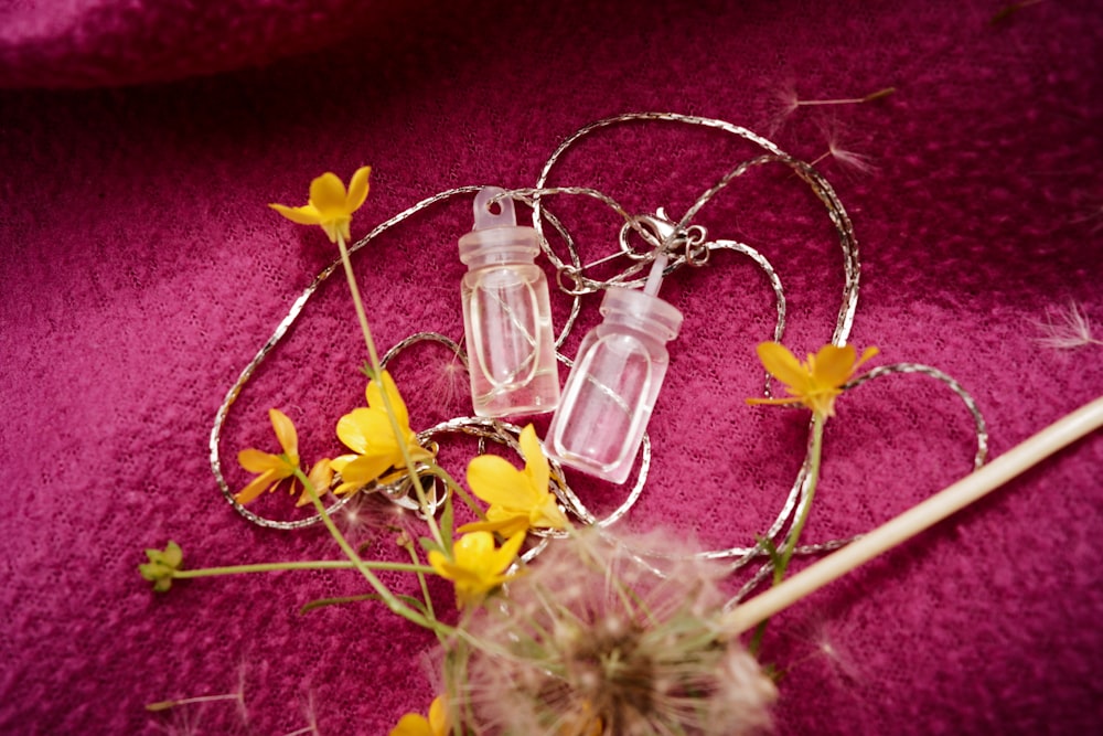 a couple of small bottles sitting on top of a purple blanket