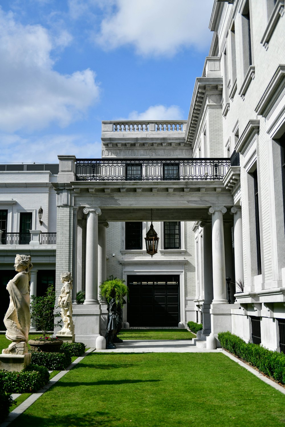 a large white building with a statue in front of it