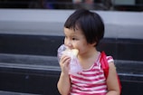 A happy child taking a bite of a homemade sandwich packed with healthy ingredients.