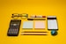 a calculator, pen, eyeglasses, notepad, pencils