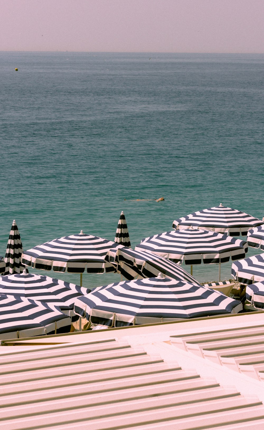 a bunch of umbrellas that are on a beach