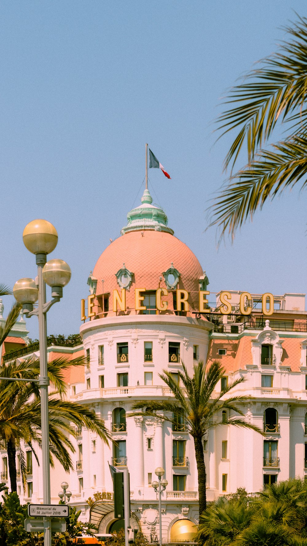 a large white building with a flag on top of it