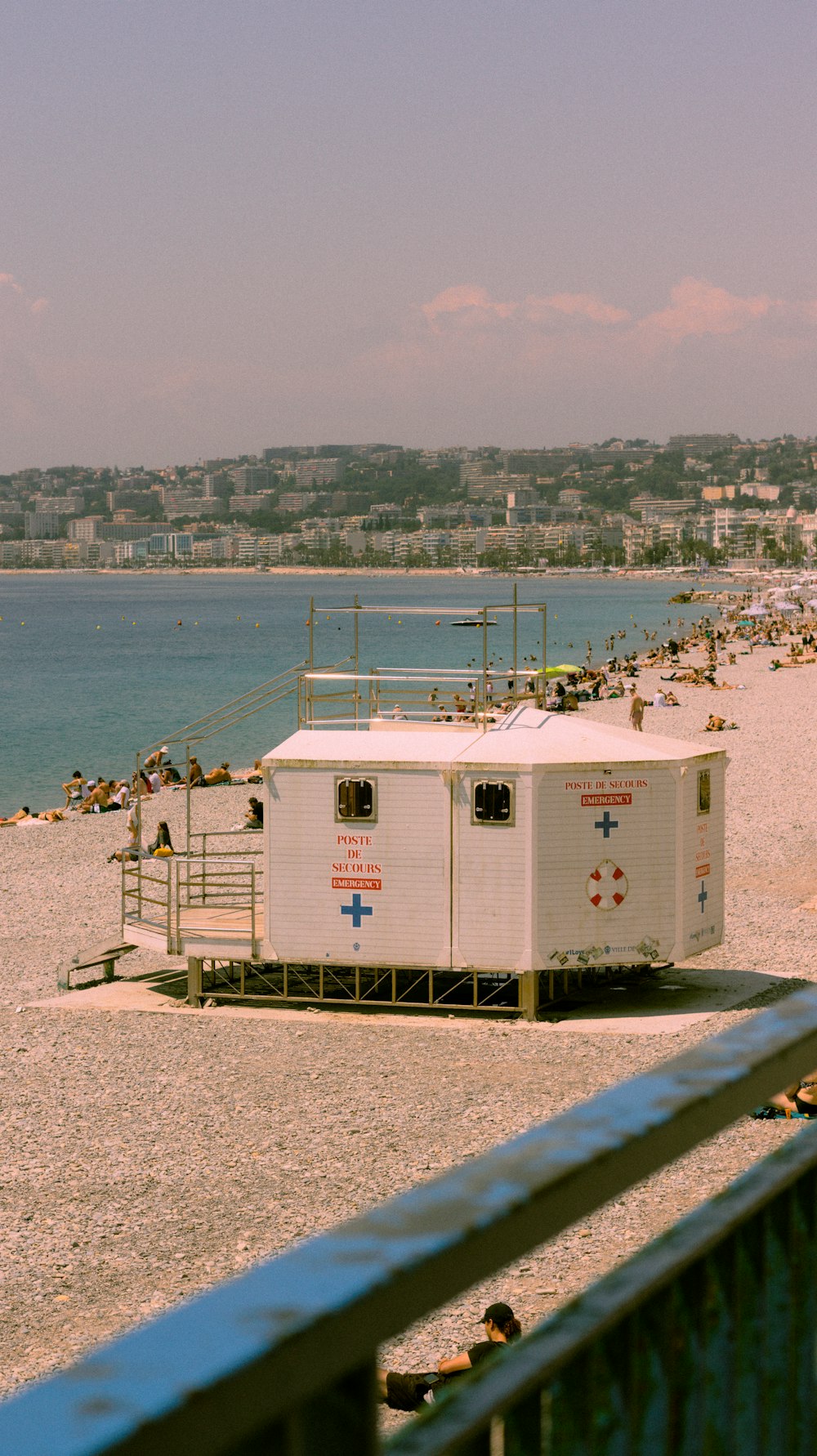 a lifeguard station on a beach next to a body of water