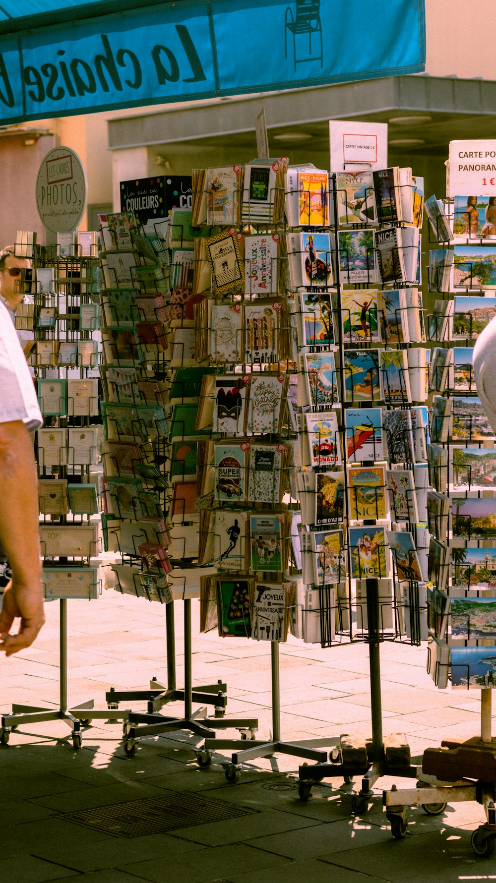 a man standing next to a display of magazines