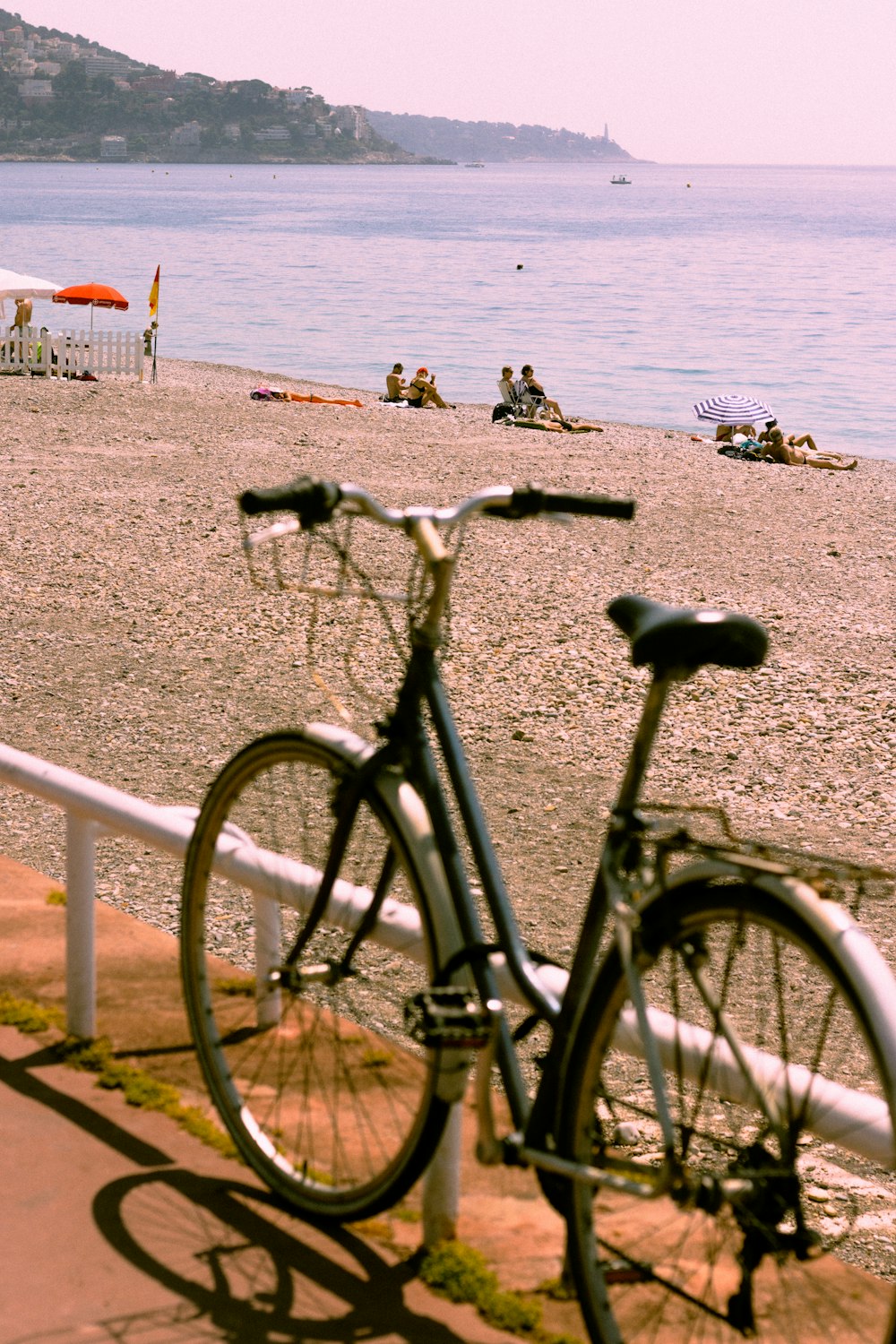 a bicycle parked on the side of a beach