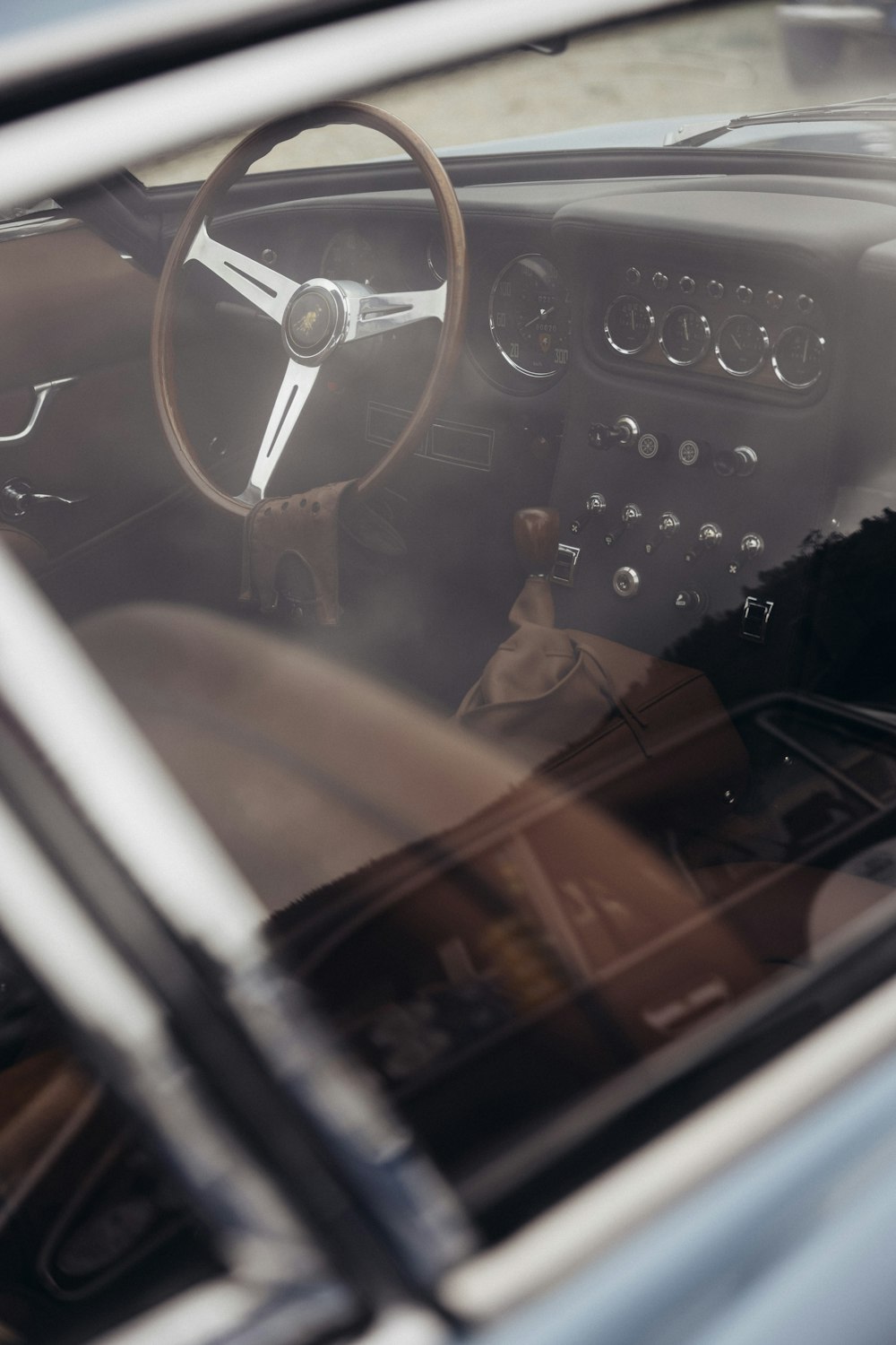 the interior of a car with a steering wheel and dashboard