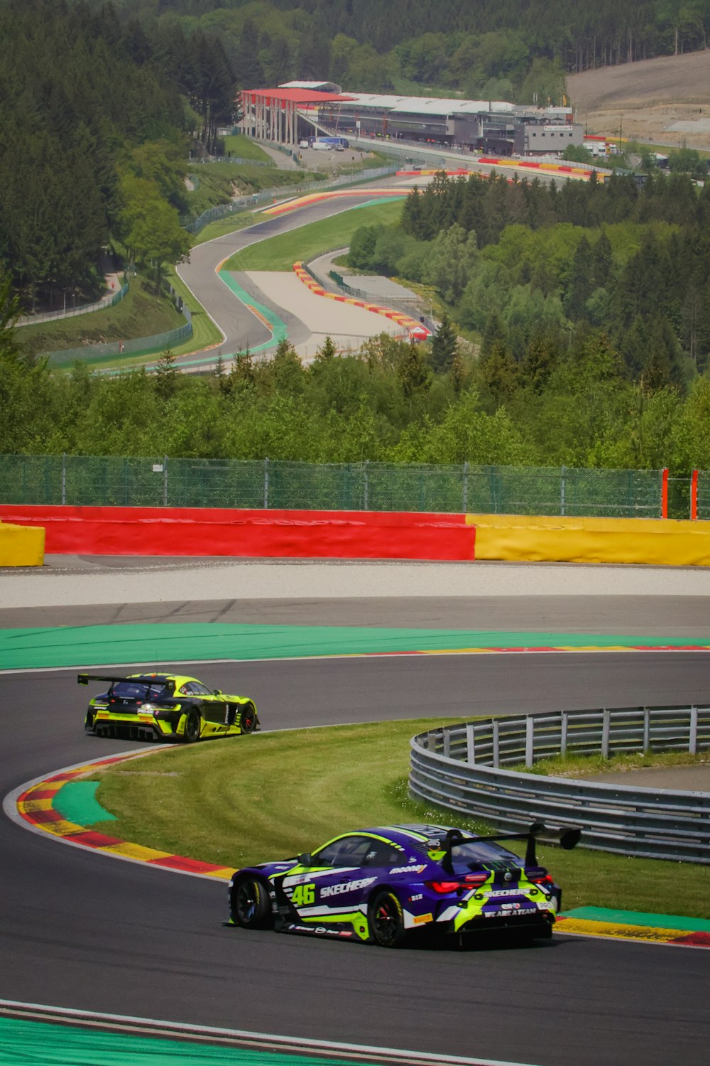 two racing cars driving on a race track