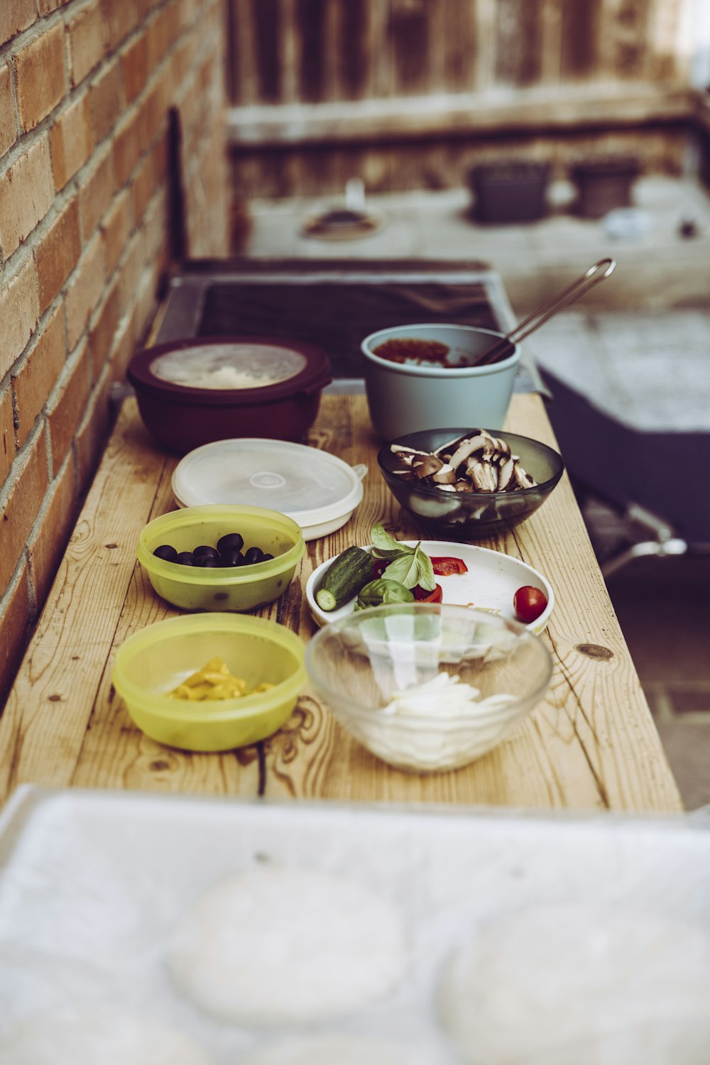 a wooden table topped with bowls of food