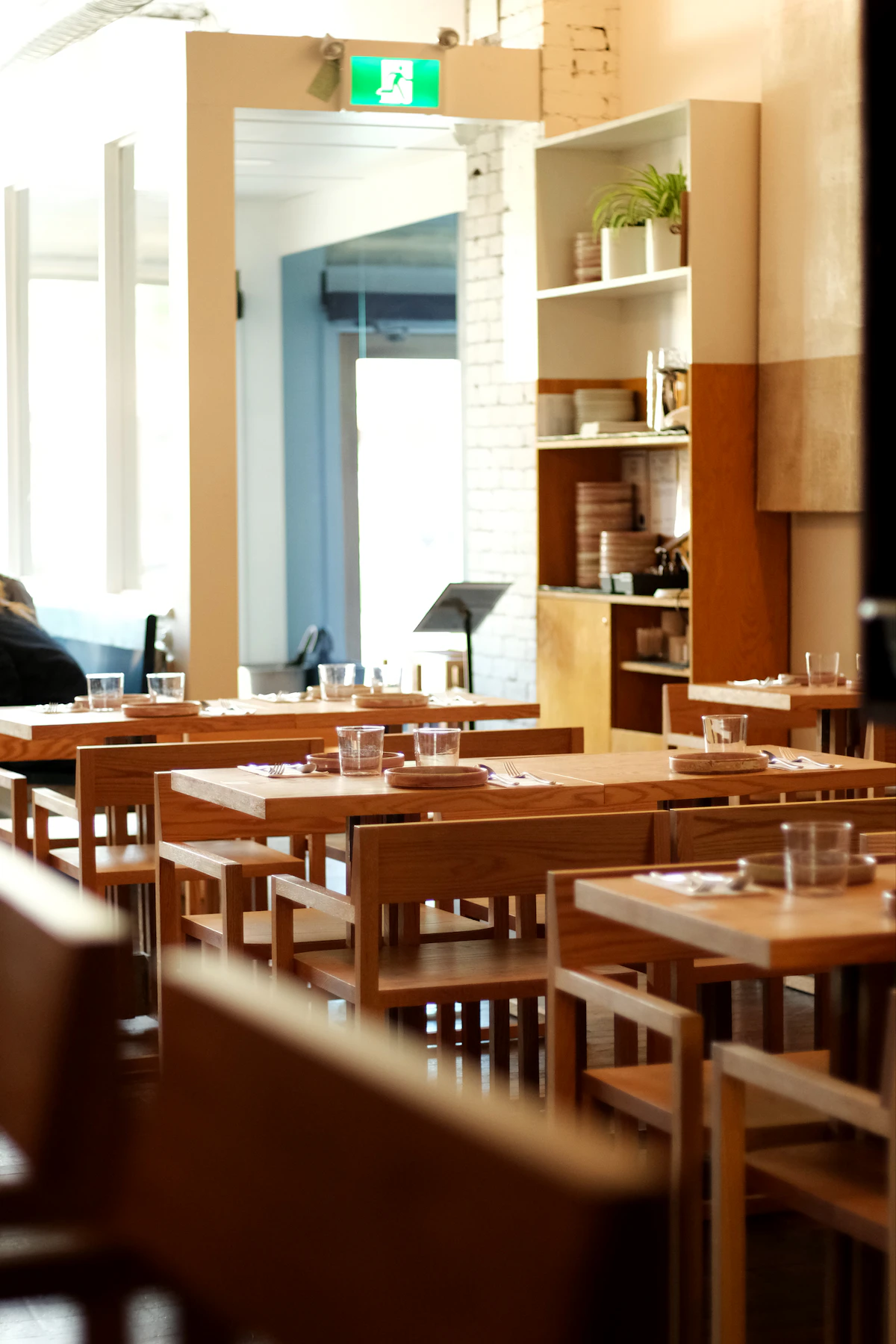Modern restaurant dining room with warm wood tables