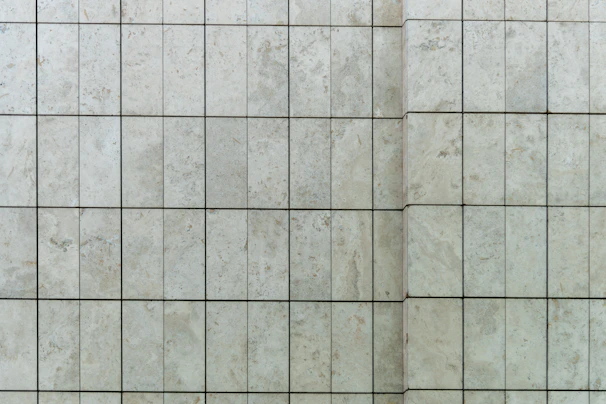 Close-up of elegant porcelain tiles with natural stone texture in a modern living room.