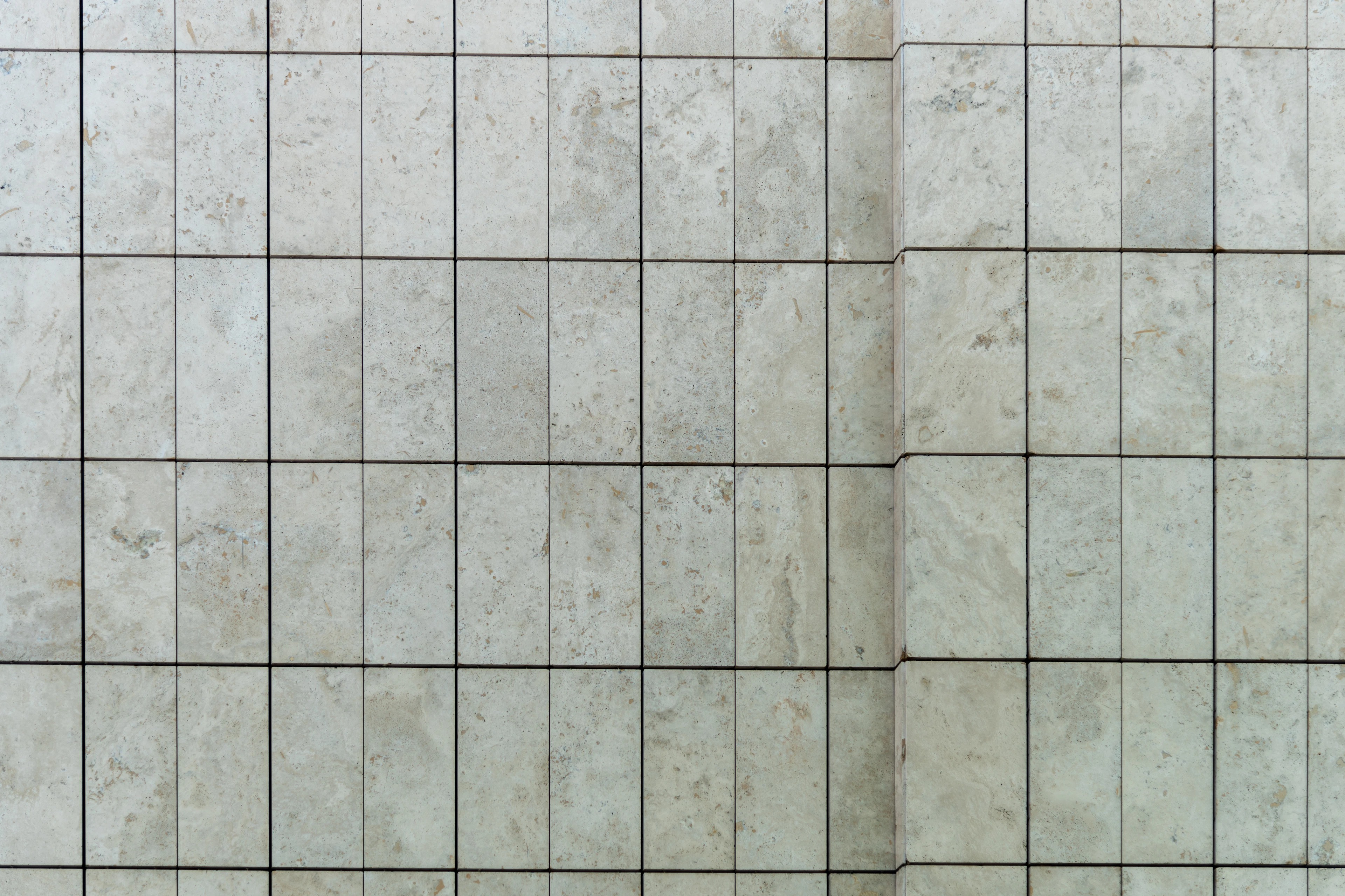 White tiled bathroom wall with clean grout lines