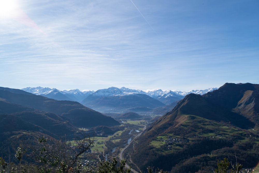 a view of a valley with mountains in the background