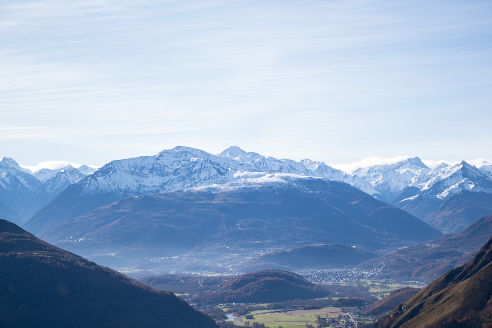 a view of a valley with mountains in the background