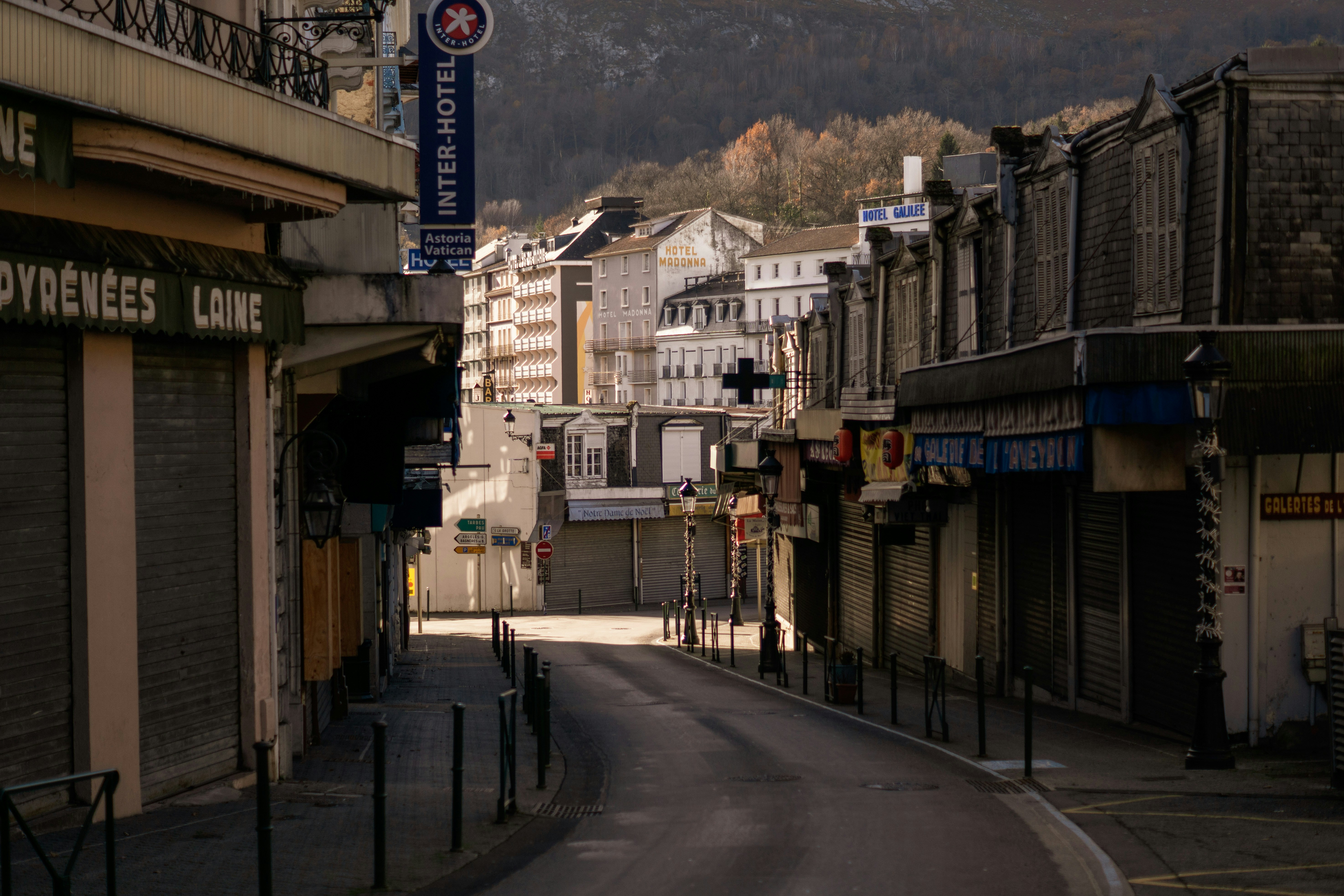 a city street with a mountain in the background