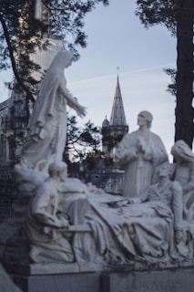 a statue of a woman laying on top of a bed