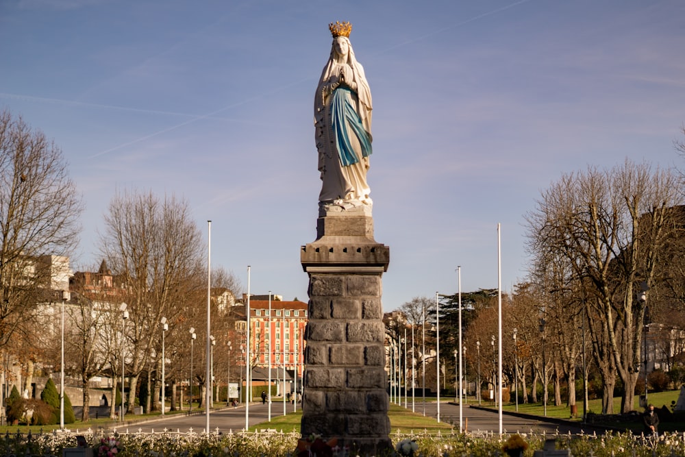 a statue of a woman standing in a park