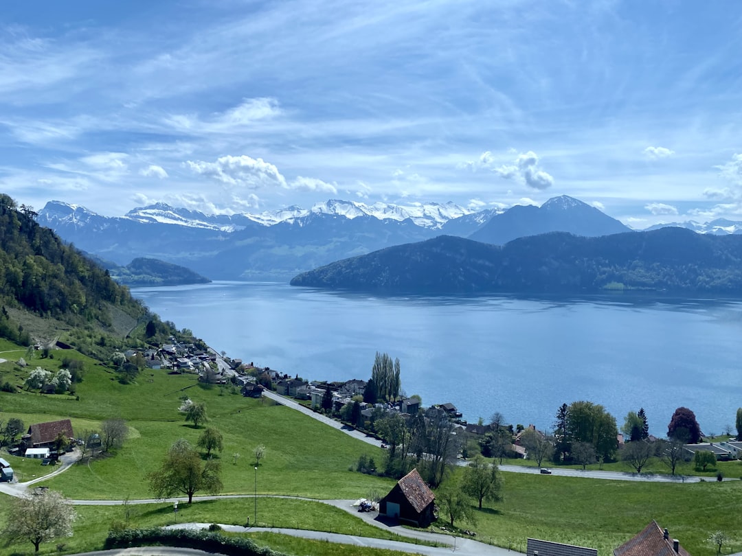 a scenic view of a lake surrounded by mountains,