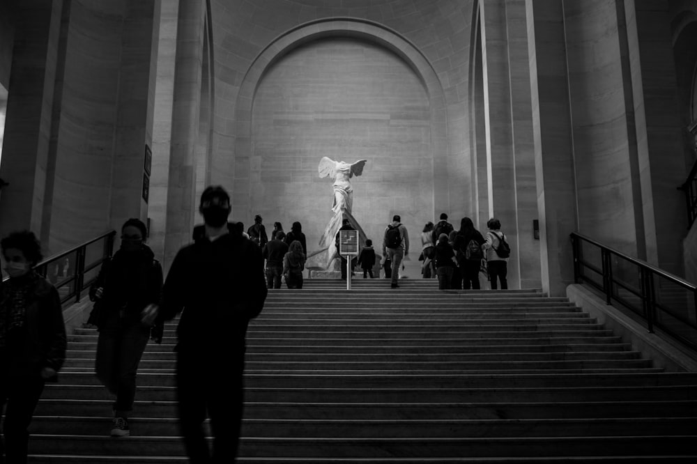 a group of people walking up a flight of stairs