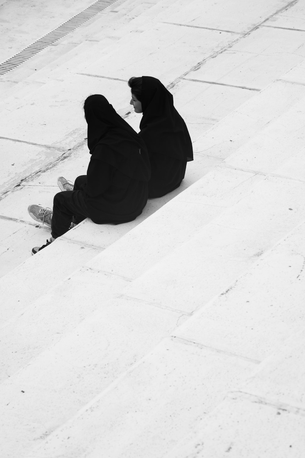 a couple of people sitting on the ground next to each other