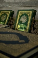 Close-up of skilled hands carefully printing Quran pages with vibrant green and orange accents