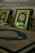 A close-up view of ornate books with intricate Arabic calligraphy and a picture of a mosque on their covers. The book covers feature a rich green background with gold embellishments.