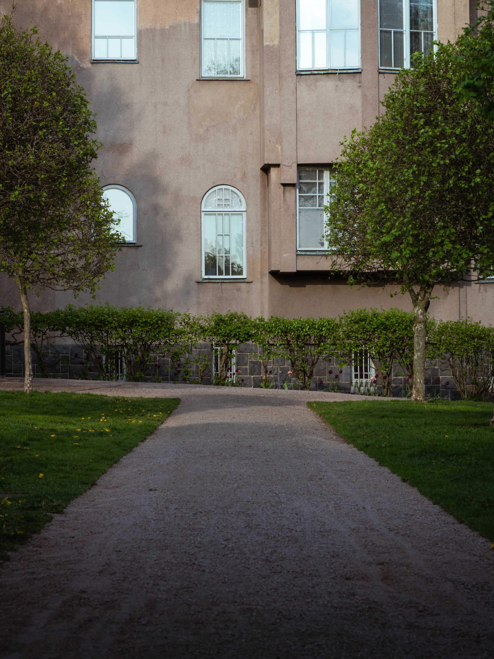 a large building with many windows and a walkway in front of it