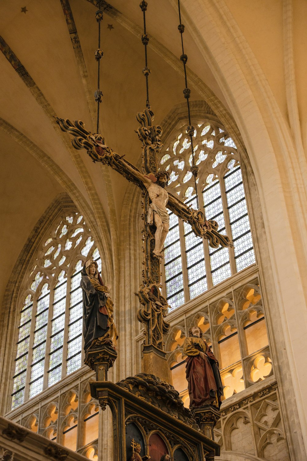 a large cross hanging from the side of a building