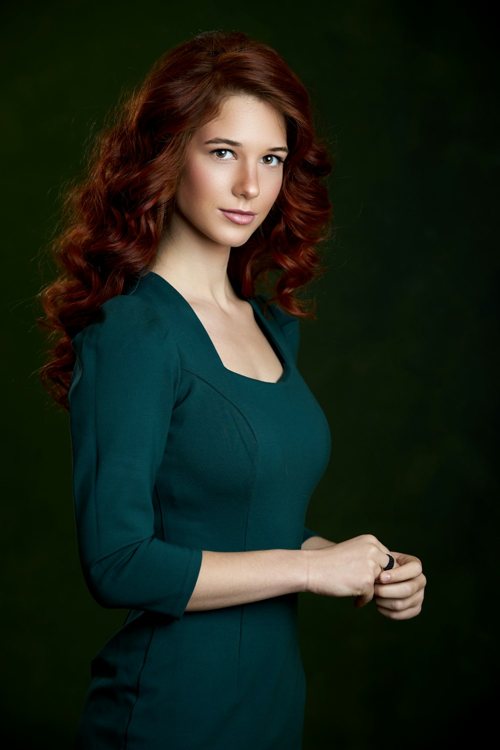 a woman in a green dress posing for a picture