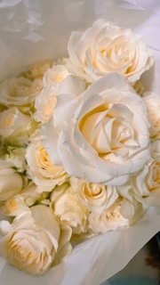 Timeless white silk rose bouquet with subtle hints of lavender, ideal for milestone celebrations.