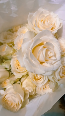 Timeless white silk rose bouquet with subtle hints of lavender, ideal for milestone celebrations.
