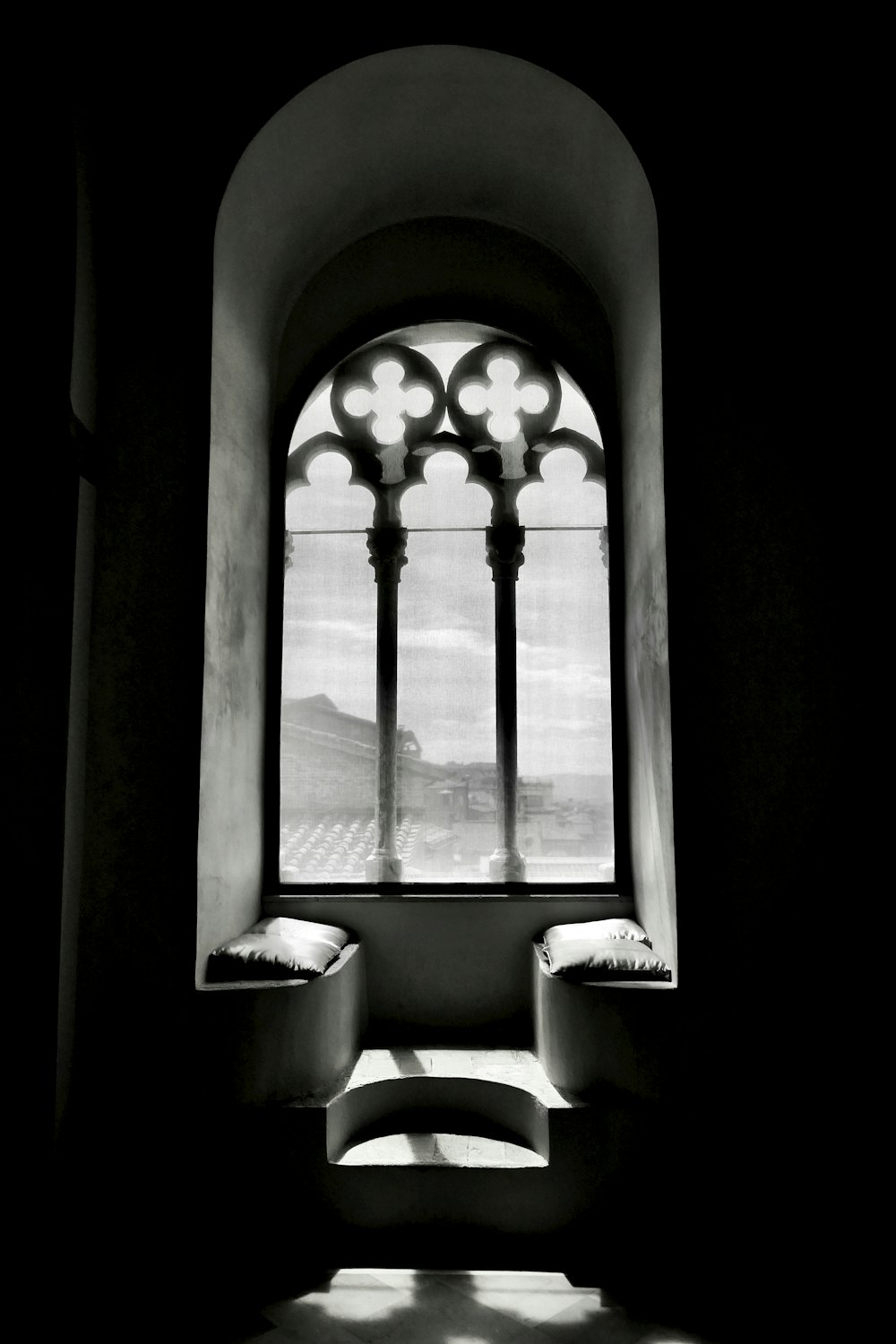 a black and white photo of a window in a building