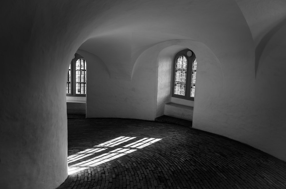 a black and white photo of a sunlit room