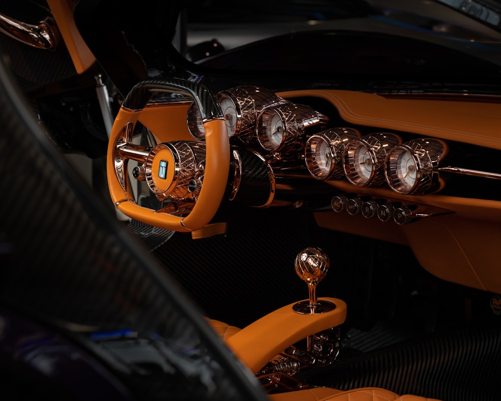 the interior of a sports car with orange leather