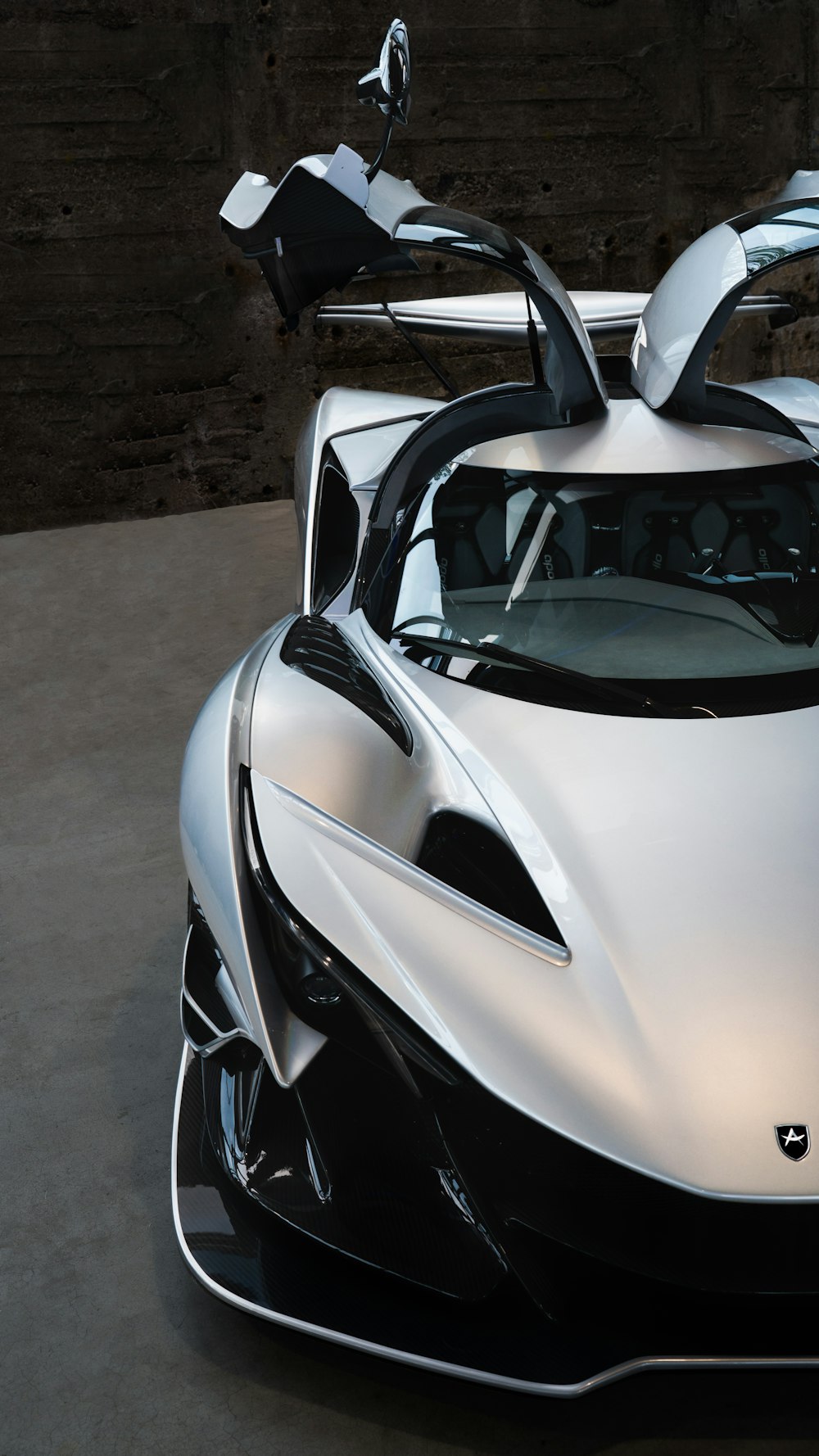 a white and black sports car parked in a garage