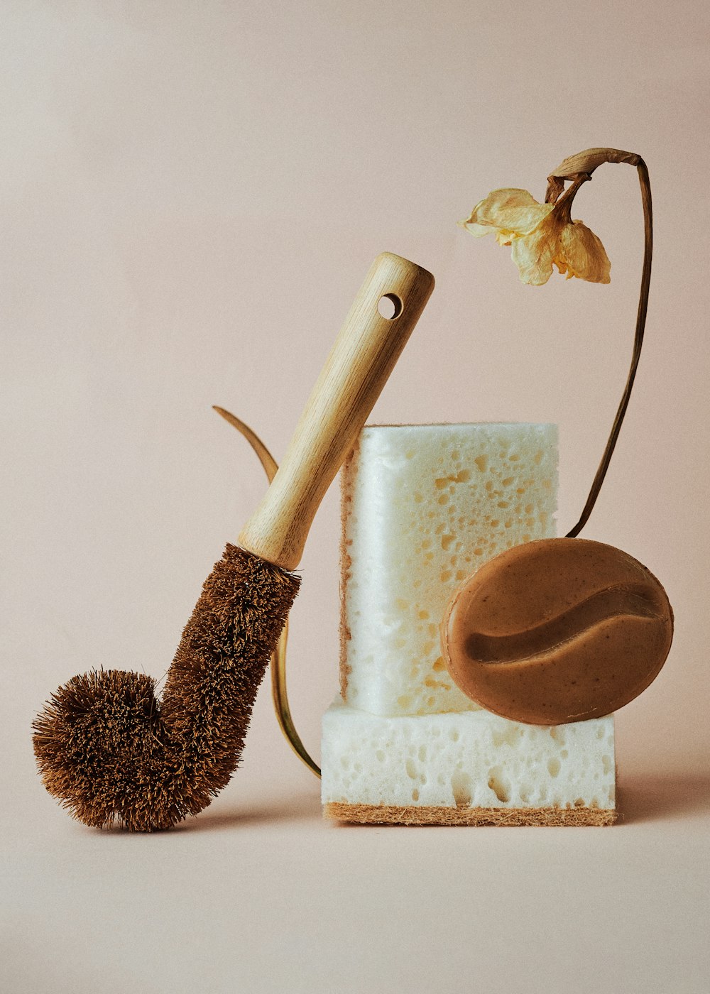 a piece of cake next to a brush and a pipe