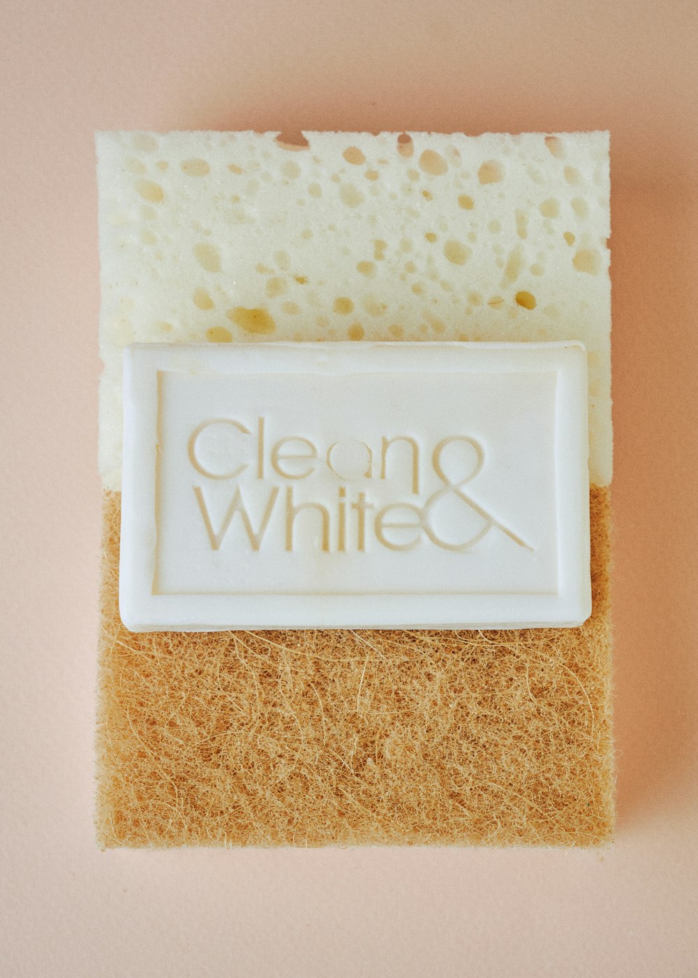 a close up of a soap bar on a pink surface