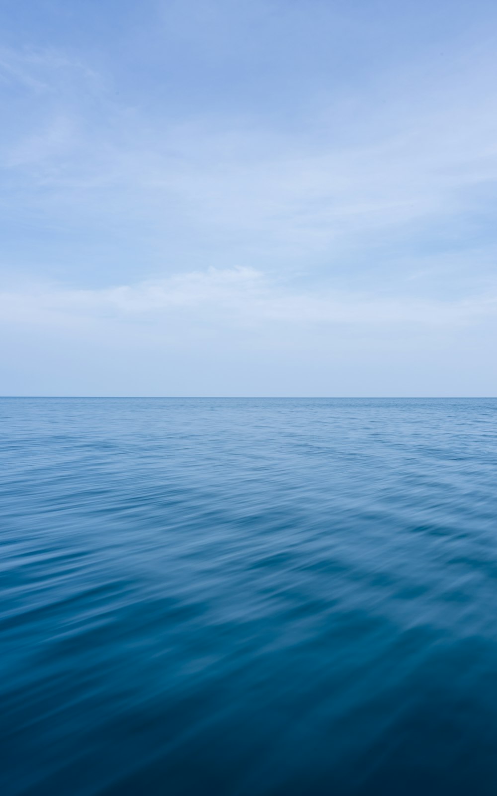 a large body of water with a sky background