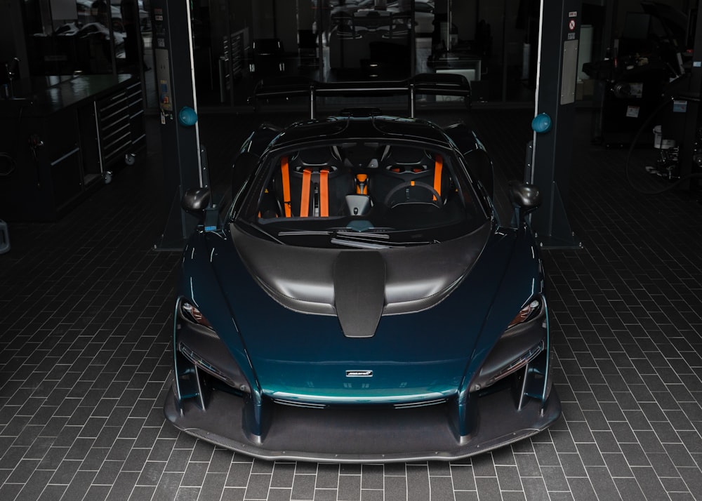 a blue sports car parked in a garage