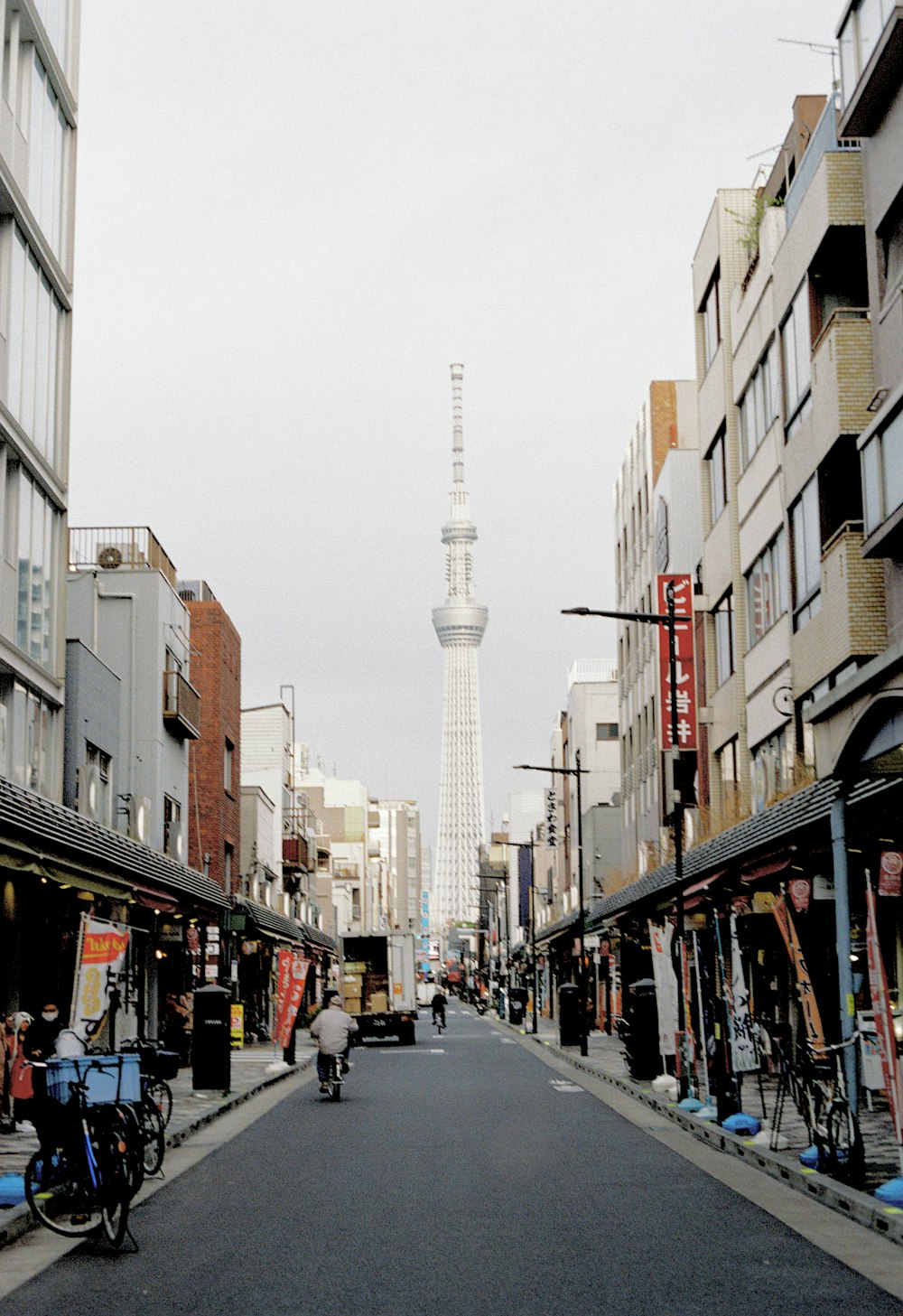 a city street with a tall tower in the background