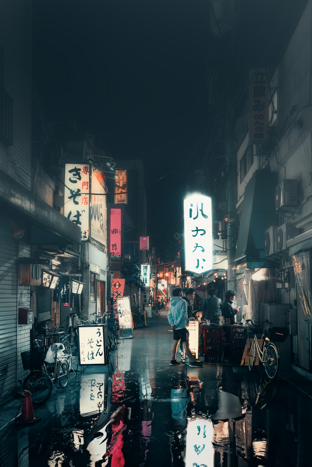 a person walking down a street at night