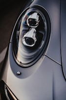 A modern car part with sleek lines, highlighted by moody lighting.