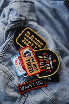 a close up of a jacket with garment patches on it