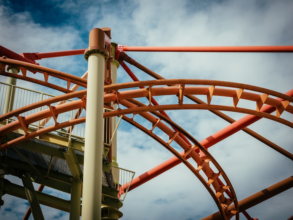a close up of a roller coaster on a cloudy day