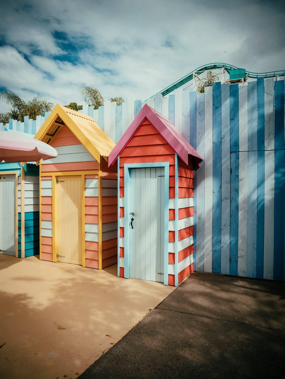 a row of colorful beach huts sitting next to each other