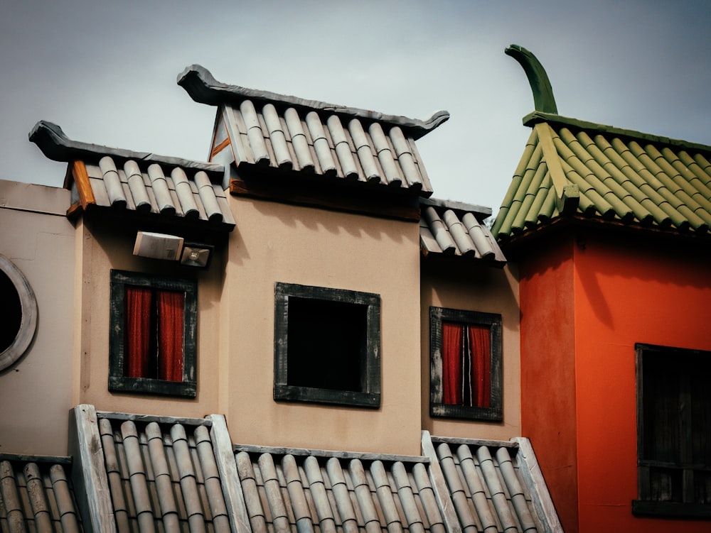 a couple of buildings that have red curtains on them