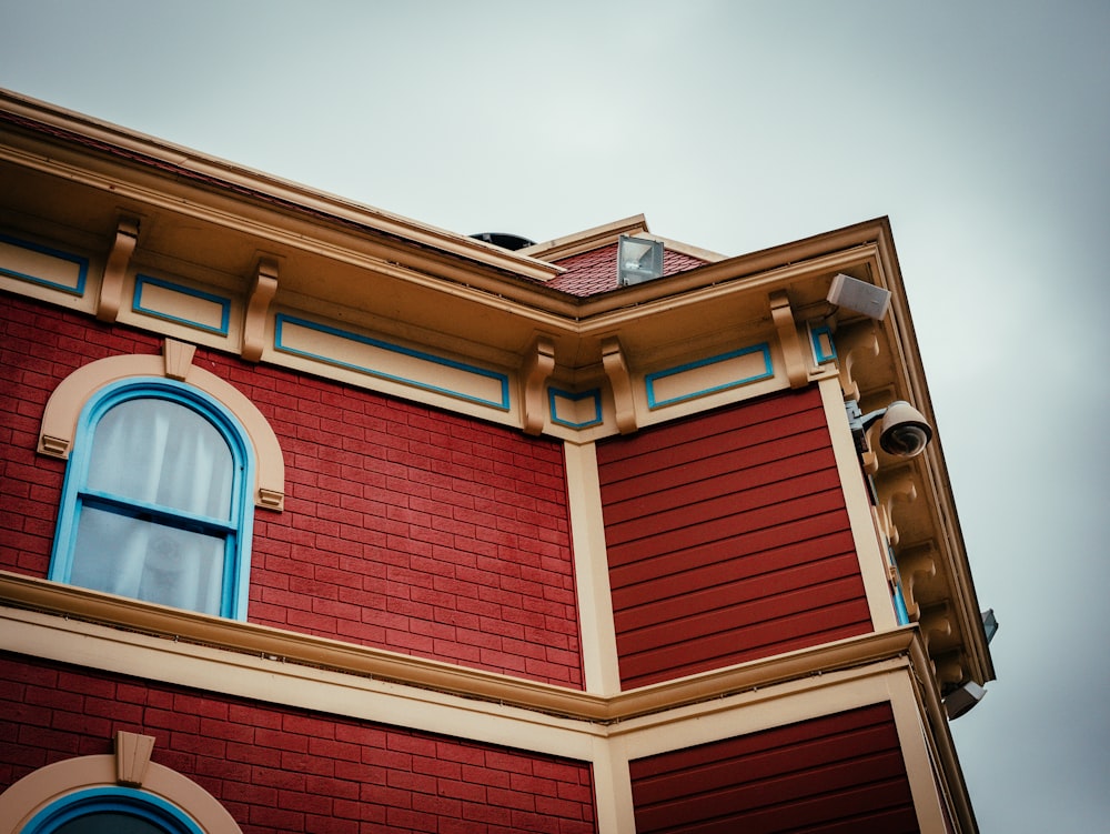 a red building with a clock on the top of it