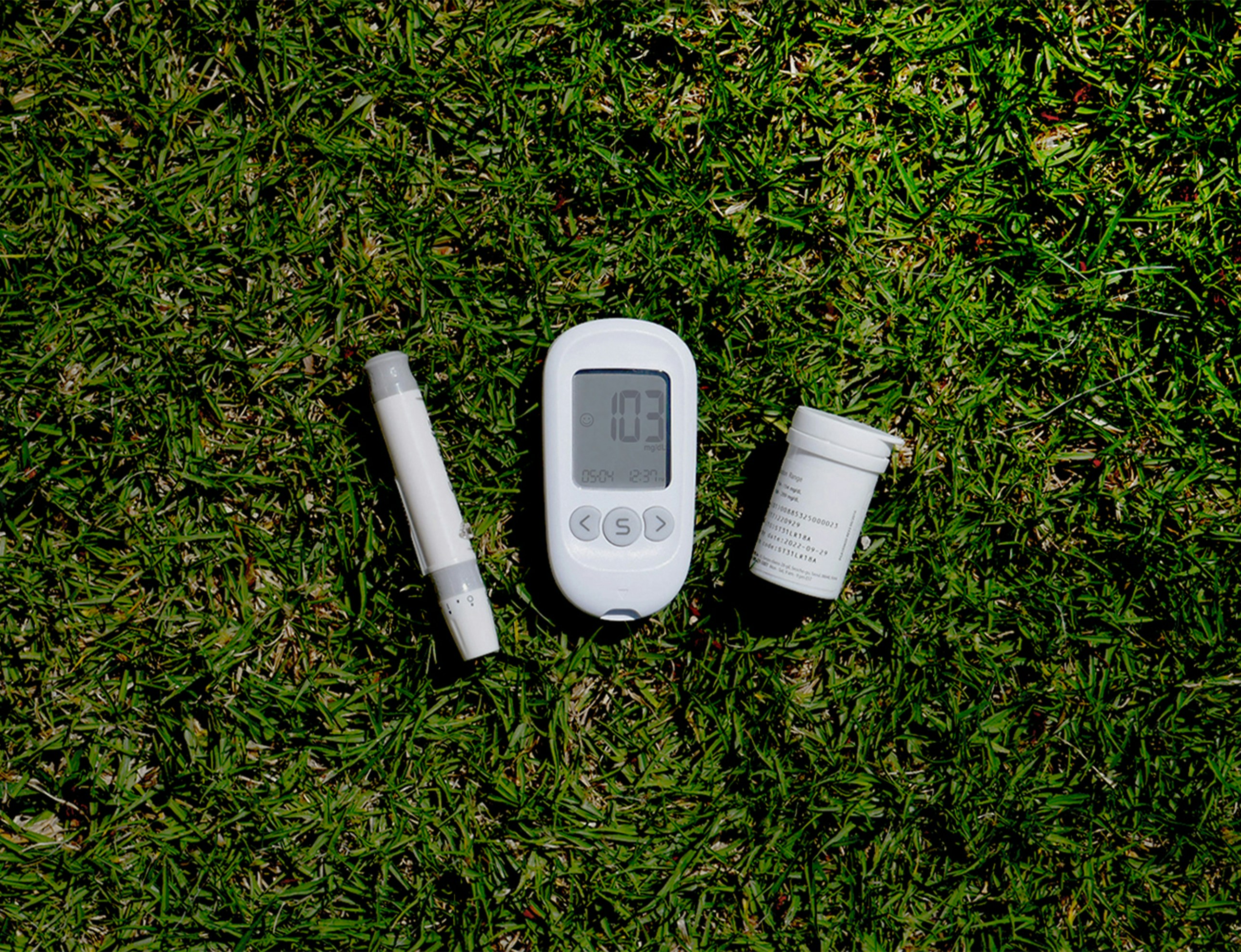 a thermometer, a thermometer, and a pill on the grass